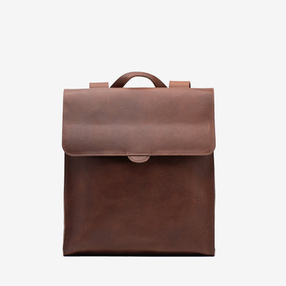 Front view of the mahogany Leather Backpack – Fibonacci with a wide flap closure and top carry handle