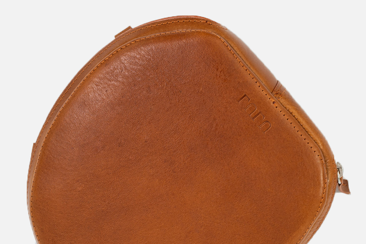 Top view of tan leather AirPods Max case with stitched edge, zipper closure, and custom monogram embossing on the lid.
