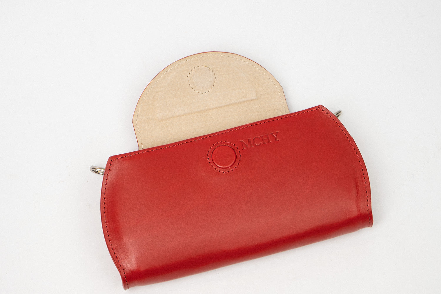 Personalized red leather AirPods Max case with magnetic flap and inner sleep-mode panel, close-up on white background