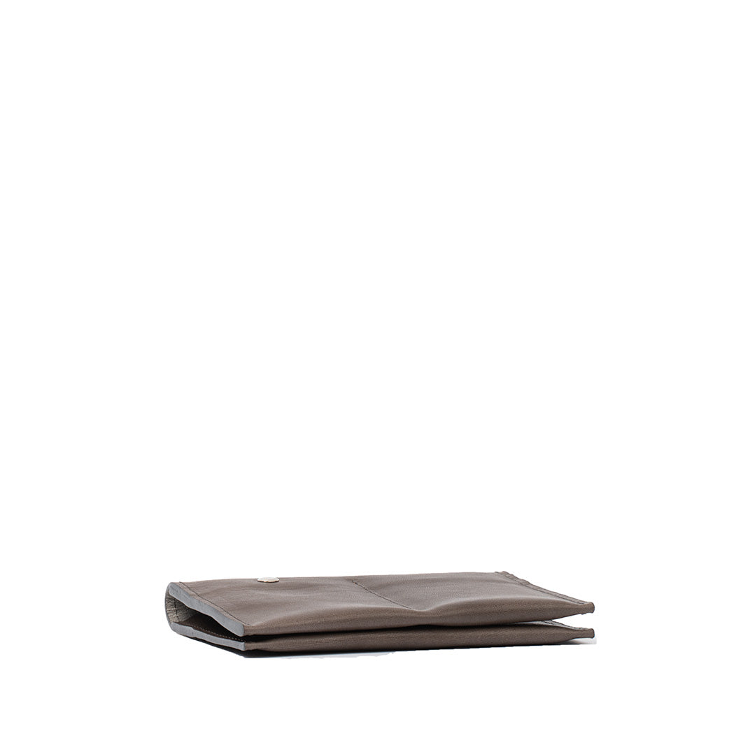 Slim leather AirTag passport holder 2.0 in gray color emphasizing its portability