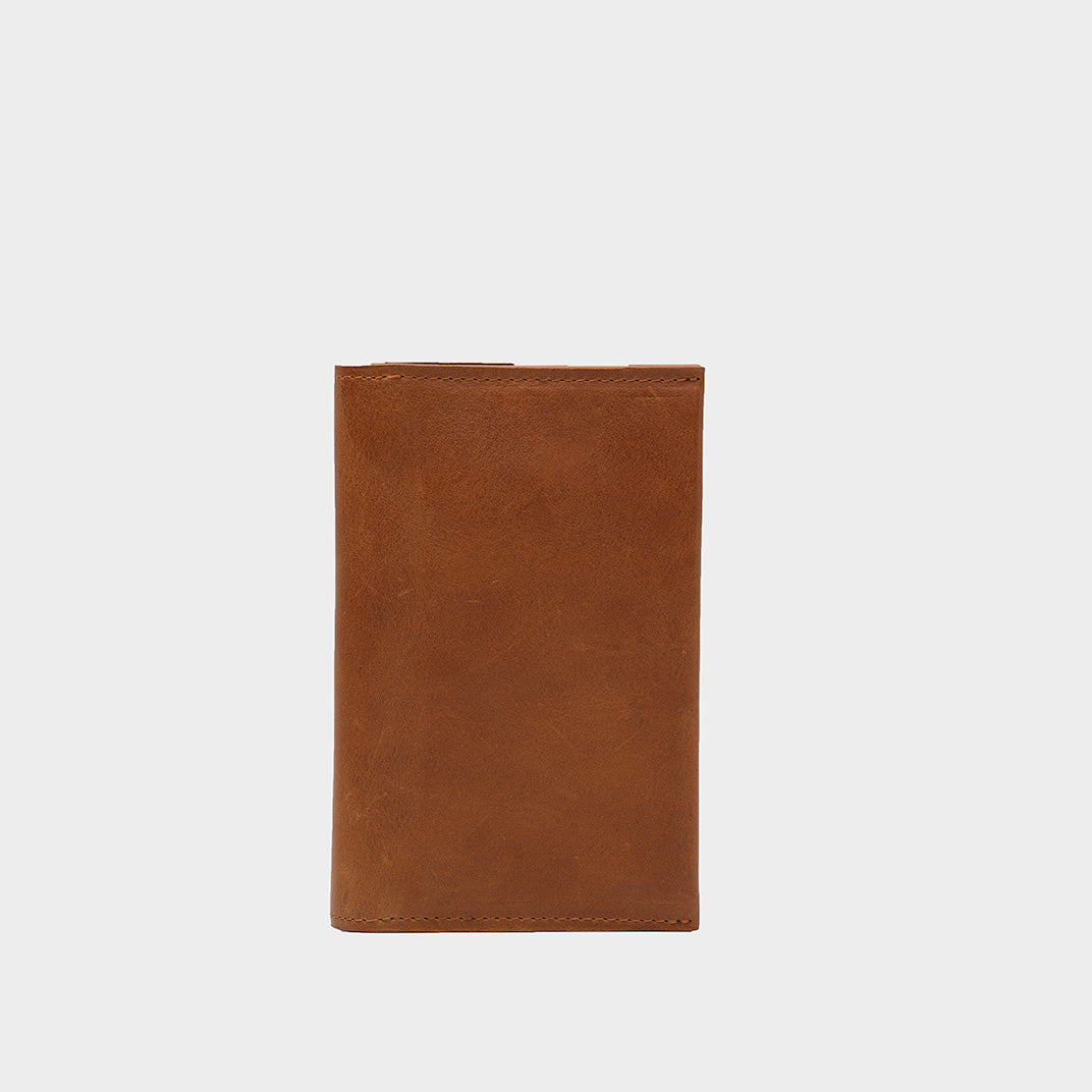 Folded tan Continental Wallet for AirTag showing the closed leather exterior