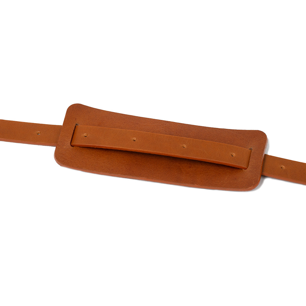Tan leather shoulder pad attached to adjustable leather strap
