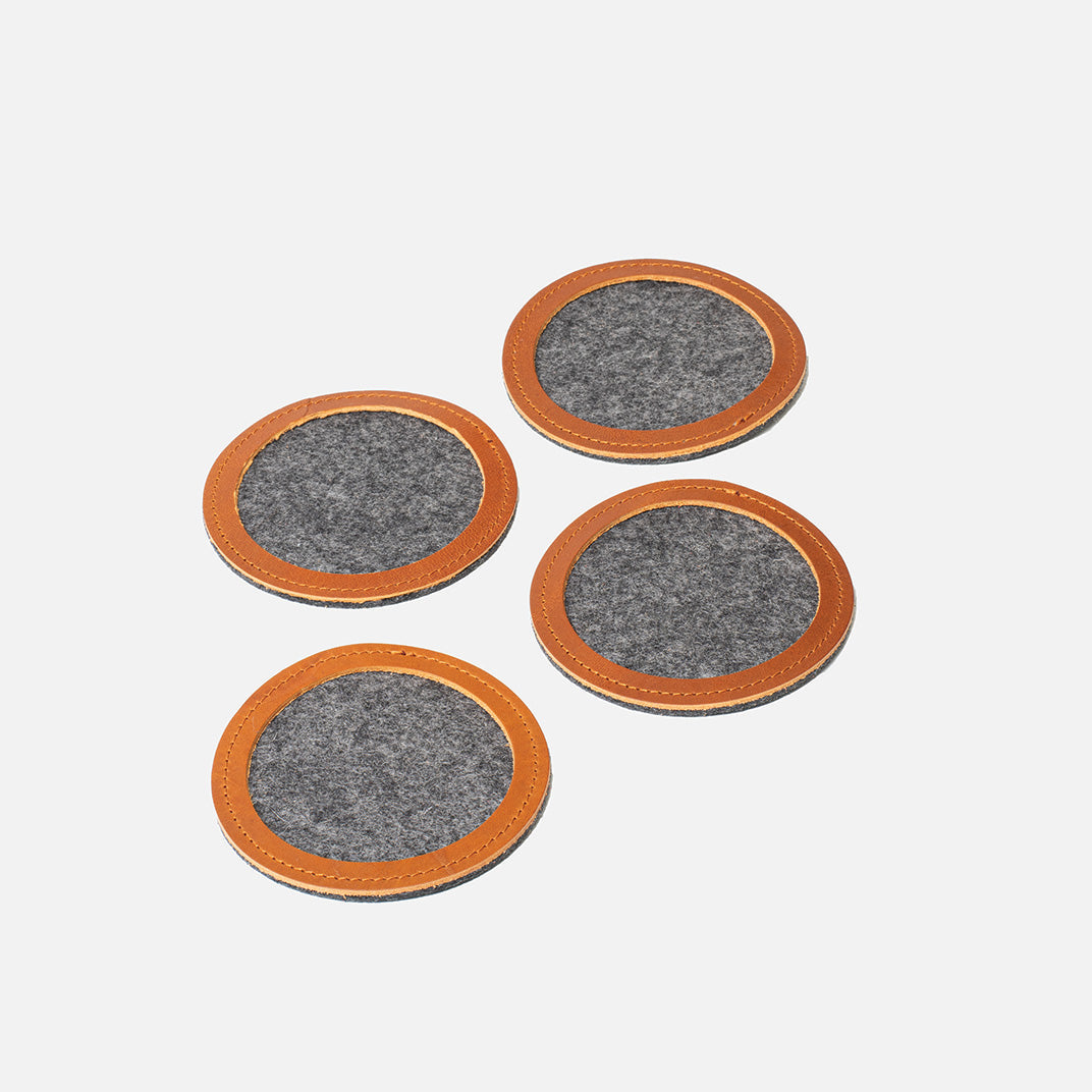Set of four round wool felt coasters with tan leather rims, 3.86 in (98 mm) diameter